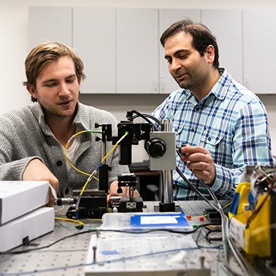 Student and professor working in lab.